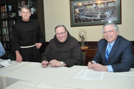 (From L-R) Siena College president Br. Edward Coughlin, OFM, Ph.D, Provincial Minister Fr. Kevin Mullen, OFM and Siena College Board of Trustees Chair Howard Foote pose after signing “Our Shared Commitment to Catholic Franciscan Higher Education”