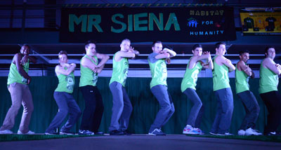Mr. Siena contestants and event organizer Matt Schiesel '15 (center) perform during this year's pageant. Photo Credit: Patrick Mann '18.