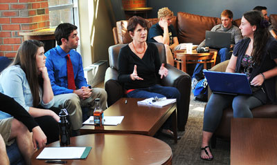 Vera Eccarius-Kelly, Ph.D. speaks with students inside Casey's. 